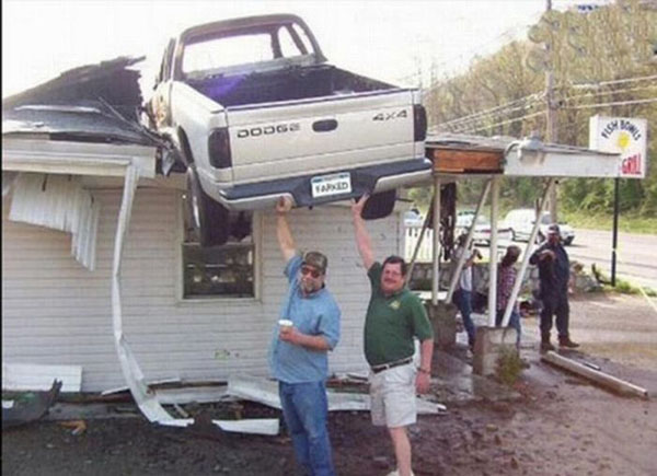  The car "parked" on the roof of the house.